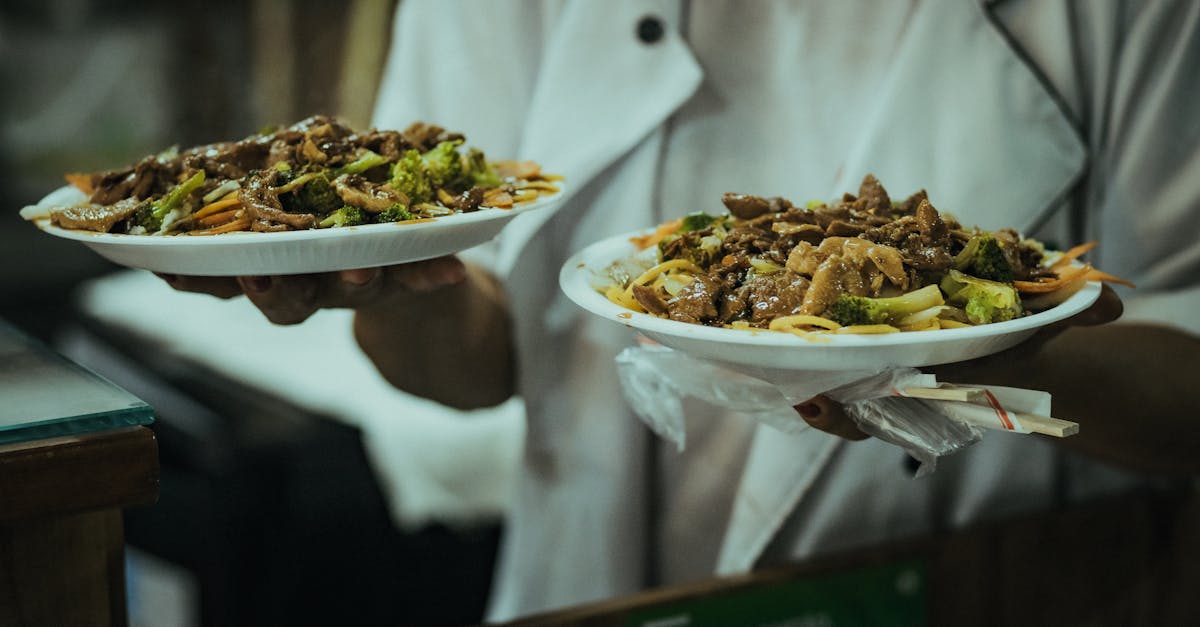 Hand holding a small plate of food, illustrating portion size estimation